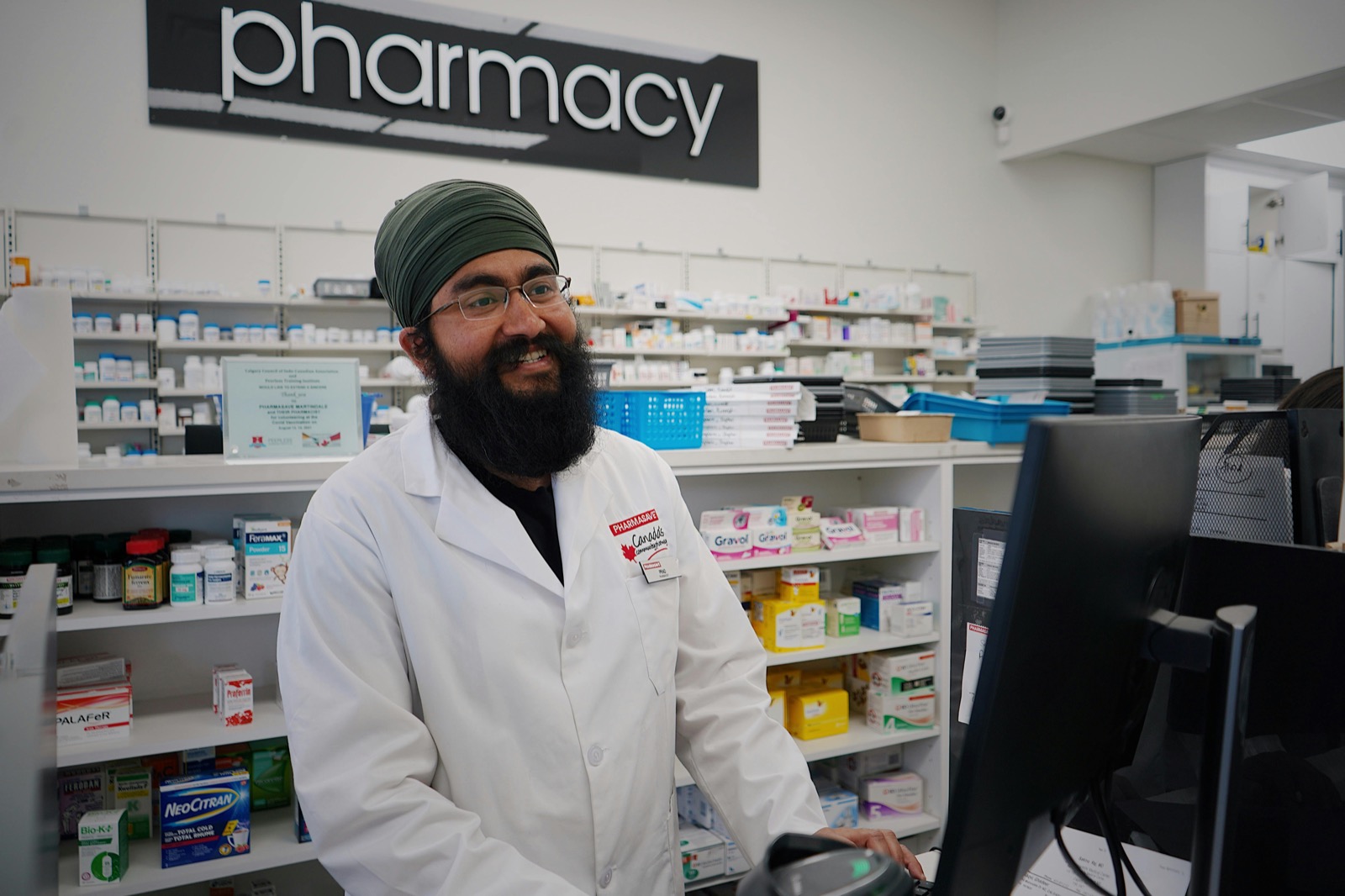 A pharmacist serving a customer at the pharmacy counter